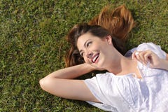 Happy relaxed woman lying on the grass stock photo Happy relaxed woman lying on the grass stock photo
