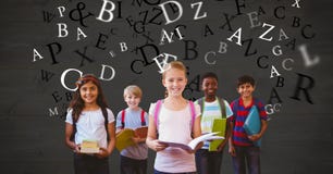 Happy school children holding books while letters flying royalty free stock photo Happy school children holding books while letters flying royalty free stock photo