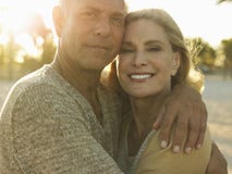 Happy Senior Couple Embracing On Beach Royalty Free Stock Photography
