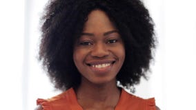 Happy smiling african american young woman face