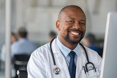 Happy smiling black doctor looking at camera