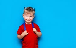 Happy Smiling Boy In Red T-shirt With Glasses On His Head Is Going To School For The First Time. Child With School Bag. Kid On Stock Image