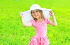 Happy smiling little girl in dress and straw hat outdoors royalty free stock images Happy smiling little girl in dress and straw hat outdoors royalty free stock images