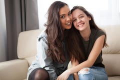 Happy Smiling Sisters On The Couch Royalty Free Stock Photo