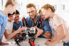 Happy smiling technical team testing quadcopter royalty free stock photography Happy smiling technical team testing quadcopter royalty free stock photography