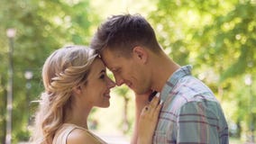 Happy smiling young man and woman approaching each other and hugging, slow-mo stock video footage Happy smiling young man and woman approaching each other and hugging, slow-mo stock video footage