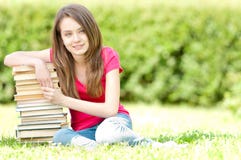 Happy Student Girl Sitting On Pile Of Books Royalty Free Stock Image Happy Student Girl Sitting On Pile Of Books Royalty Free Stock Image