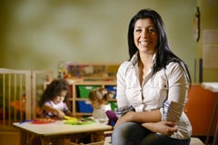 Happy teacher with children eating in kindergarten royalty free stock photography Happy teacher with children eating in kindergarten royalty free stock photography