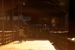 Happy two children silhouette playing run in bridge on evening light. Stock Photo Happy two children silhouette playing run in bridge on evening light. Stock Photo