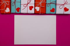 Happy Valentines day composition: white blank of paper with love gift boxes on pink background royalty free stock photography Happy Valentines day composition: white blank of paper with love gift boxes on pink background royalty free stock photography