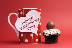 Happy Valentines Day Message On Red Polka Dot Mug With Chocolate Cupcake Stock Image