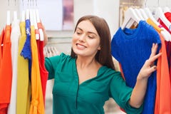 Happy woman choosing clothes at clothing store stock photos Happy woman choosing clothes at clothing store stock photos