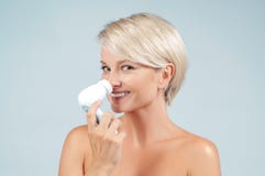 Happy woman cleaning face skin with brush. Beauty and spa. royalty free stock image Happy woman cleaning face skin with brush. Beauty and spa. royalty free stock image