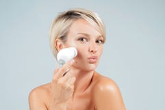 Happy woman cleaning face skin with brush. Beauty and spa. stock image Happy woman cleaning face skin with brush. Beauty and spa. stock image