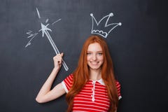 Happy woman with crown and magic drawn on blackboard background royalty free stock photography Happy woman with crown and magic drawn on blackboard background royalty free stock photography