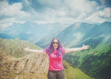 Happy woman hiker standing on the top of mountain outdoor stock images Happy woman hiker standing on the top of mountain outdoor stock images