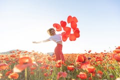 Happy woman holding balloons in nature. High quality photo