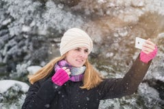 Cheerful woman taking self portrait by using her smart phone. stock photo Cheerful woman taking self portrait by using her smart phone. stock photo