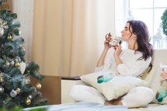 Happy woman in white knitted wearing relax at home for Christmas royalty free stock images Happy woman in white knitted wearing relax at home for Christmas royalty free stock images