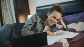 Happy woman working with documents at home. Smiling woman doing paperwork stock video Happy woman working with documents at home. Smiling woman doing paperwork stock video