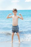 Happy 7 years boy in victory success gesture on the beach. Stock Photography Happy 7 years boy in victory success gesture on the beach. Stock Photography