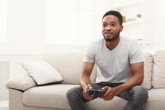 Happy young african-american man at home playing video games stock photography Happy young african-american man at home playing video games stock photography