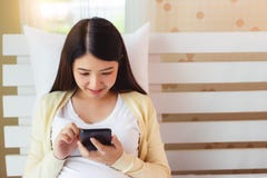 Happy young asian woman using smart phone for online shopping, financial, transfer money, internet banking, searching information