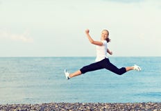 Happy young beautiful woman jumping at beach on the Sea royalty free stock images Happy young beautiful woman jumping at beach on the Sea royalty free stock images