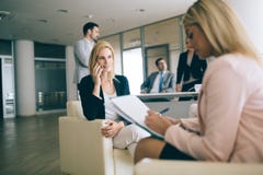 Happy young businesswomen doing paperwork in office royalty free stock photos Happy young businesswomen doing paperwork in office royalty free stock photos