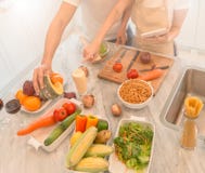 Happy young couple cooking together in the kitchen at home. looking at tablet pc stock images Happy young couple cooking together in the kitchen at home. looking at tablet pc stock images