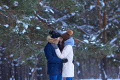 Happy young couple hugs in winter snowy woods stock photos Happy young couple hugs in winter snowy woods stock photos