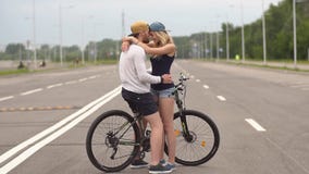Happy young couple smiling laughing riding bicycle, slow motion. stock video Happy young couple smiling laughing riding bicycle, slow motion. stock video