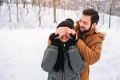 Happy Young Couple in Winter . Family Outdoors. man and woman looking upwards and laughing. Love, fun, season and people royalty free stock images Happy Young Couple in Winter . Family Outdoors. man and woman looking upwards and laughing. Love, fun, season and people royalty free stock images