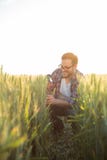 Happy young farmer or agronomist checking seed development and looking for parasites with magnifying glass royalty free stock image Happy young farmer or agronomist checking seed development and looking for parasites with magnifying glass royalty free stock image