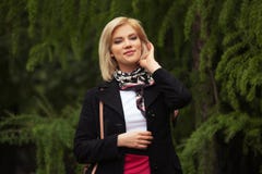 Happy young fashion blond woman walking in city park stock photography Happy young fashion blond woman walking in city park stock photography