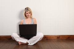 Happy young girl on floor surfing internet at home Stock Photo Happy young girl on floor surfing internet at home Stock Photo