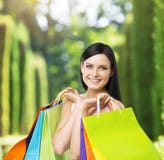 A happy young lady with the colourful shopping bags from the fancy shops. Royalty Free Stock Photography A happy young lady with the colourful shopping bags from the fancy shops. Royalty Free Stock Photography