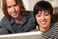Happy Young Man And Woman Using Laptop Together Royalty Free Stock Photos