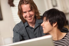 Happy Young Man And Woman Using Laptop Together Royalty Free Stock Images