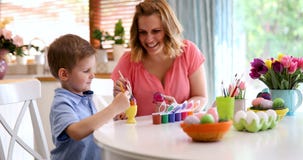 Happy young mother and son are painting Easter eggs royalty free stock photo Happy young mother and son are painting Easter eggs royalty free stock photo
