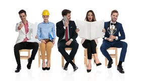 Happy young people sitting and waiting for a job interview stock images Happy young people sitting and waiting for a job interview stock images
