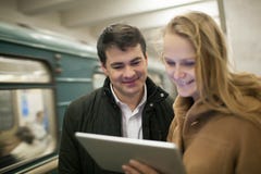 Happy young people with touch pad in subway royalty free stock photos Happy young people with touch pad in subway royalty free stock photos