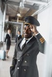 Happy Young Pilot In Airport Looking Stock Photo