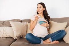 Happy young pregnant woman having healthy breakfast stock images Happy young pregnant woman having healthy breakfast stock images