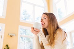 Happy young woman drinking coffee Royalty Free Stock Photography Happy young woman drinking coffee Royalty Free Stock Photography