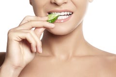 Happy young woman eating cucumber. Healthy smile with white teeth stock photography Happy young woman eating cucumber. Healthy smile with white teeth stock photography