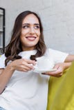 happy young woman holding cup of coffee and looking away stock image happy young woman holding cup of coffee and looking away stock image