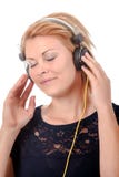 Happy young woman listening to music through headphones royalty free stock image Happy young woman listening to music through headphones royalty free stock image