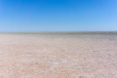 Hard flat surface of salt pan stretching to horizon Royalty Free Stock Image Hard flat surface of salt pan stretching to horizon Royalty Free Stock Image
