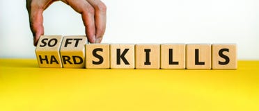 Hard skills versus soft skills. Hand flips cubes and changes the expression `hard skills` to `soft skills` or vice versa.